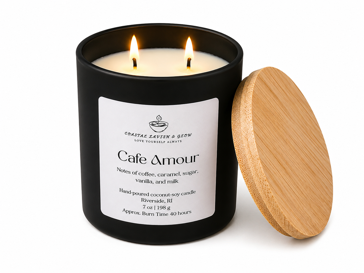 Candle in a black tin labeled 'Cafe Amour' with a wooden lid on a white background