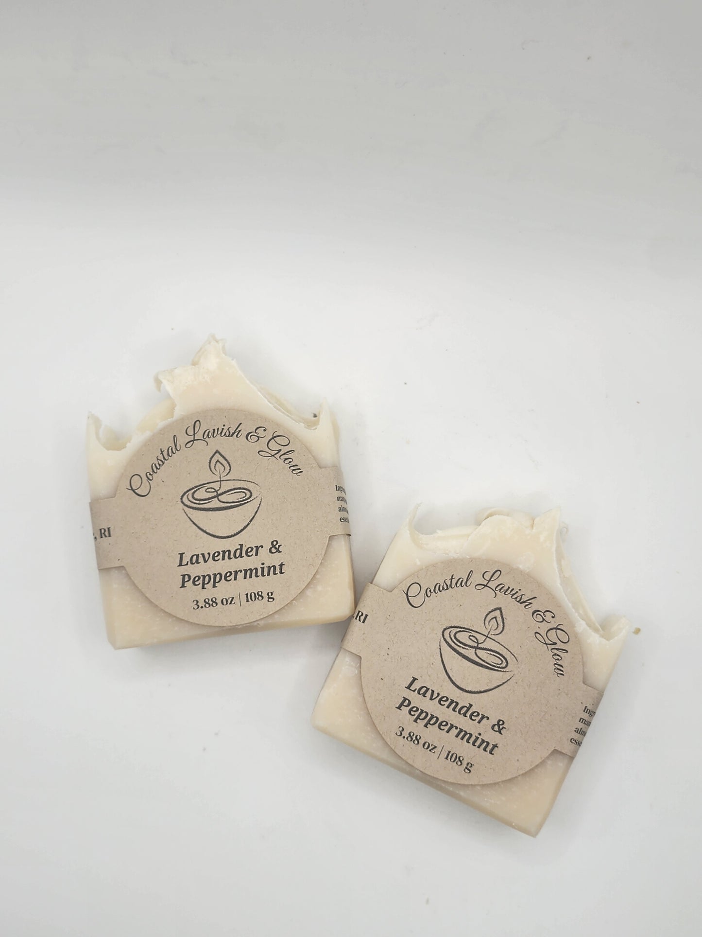 Two soap bars with circular labels on a white background