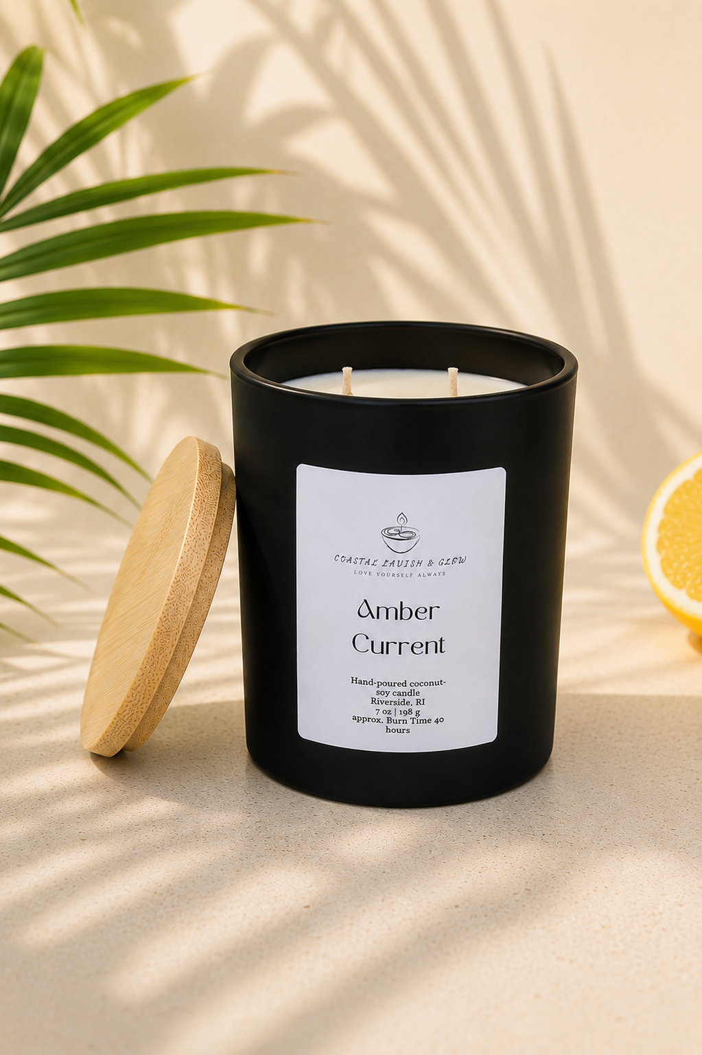 Black candle "Amber Current" with a wooden lid on a beige surface with green leaves and a lemon in the background