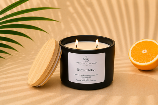 "Berry Chiffon" black candle with a wooden lid and half an orange on a beige background