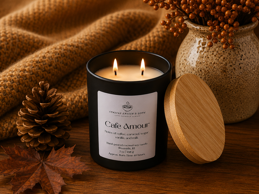 Candle labeled 'Cafe Amour' with a wooden lid and decorative elements on a wooden surface.