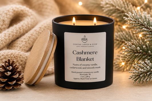 Candle labeled 'Cashmere Blanket' with festive decorations in the background