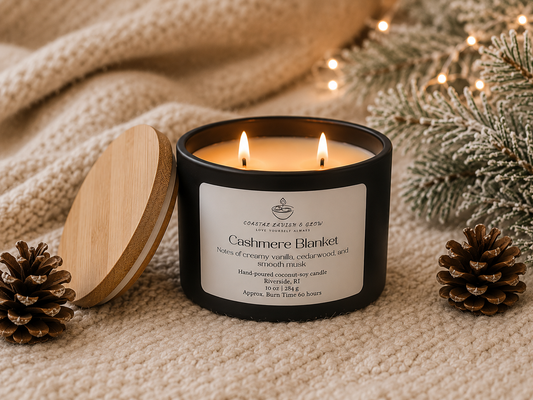 "Cashmere Blanket" candle with wooden lid on a textured surface with decorative elements