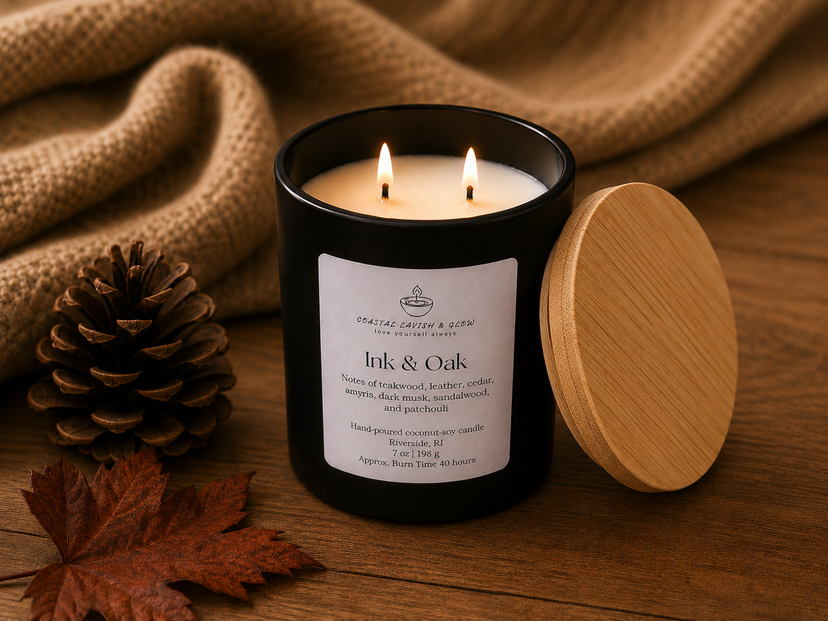 Candle labeled 'Ink & Oak' with a wooden lid and decorative elements on a wooden surface.