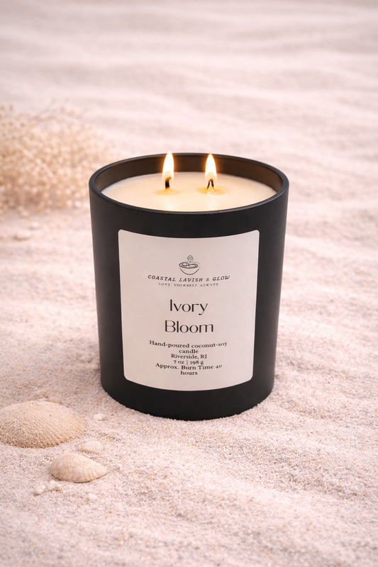 Ivory Bloom Candle on a beachy background - vanilla-scented candle that also contains notes of green leaves, jasmine, sandalwood, musk scent