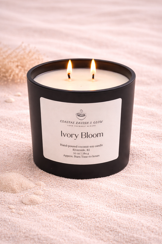 Ivory Bloom Candle on a beachy background - vanilla-scented candle that also contains notes of green leaves, jasmine, sandalwood, musk scent