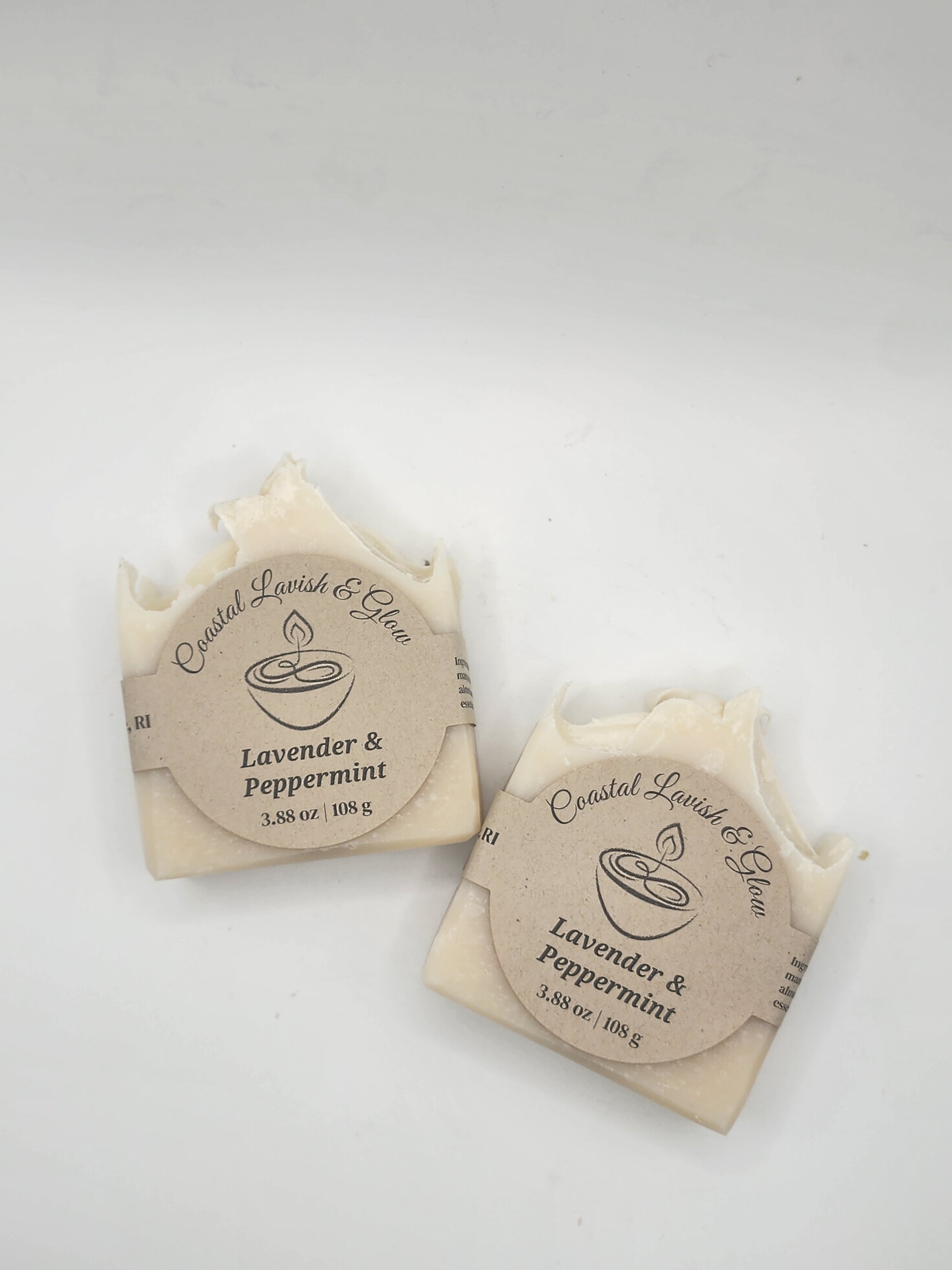 Two soap bars with circular labels on a white background