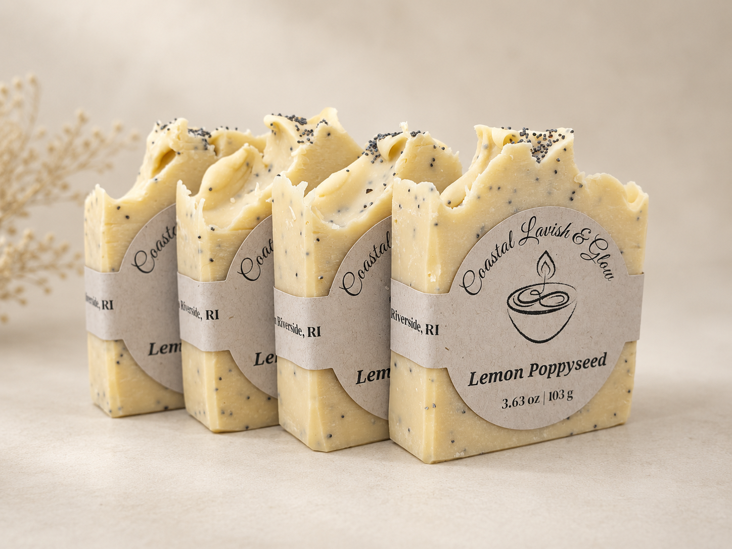 Four bars of Lemon Poppyseed soap with visible branding on a neutral background