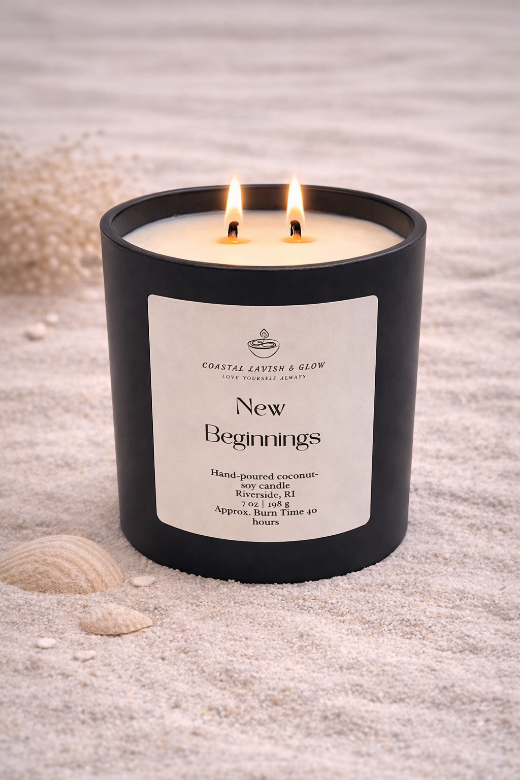 New Beginnings - Black candle with a wooden lid on a sandy surface.  Orange peel, ginger, nutmeg, cinnamon scent.