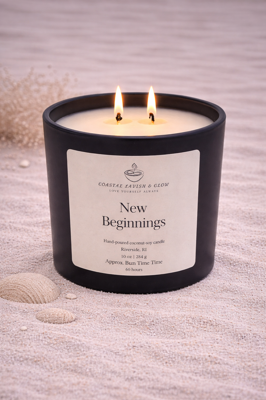 New Beginnings - black glass candle with a wooden lid on a sandy background.  Orange Peel, Ginger, Nutmeg, Cinnamon Scent