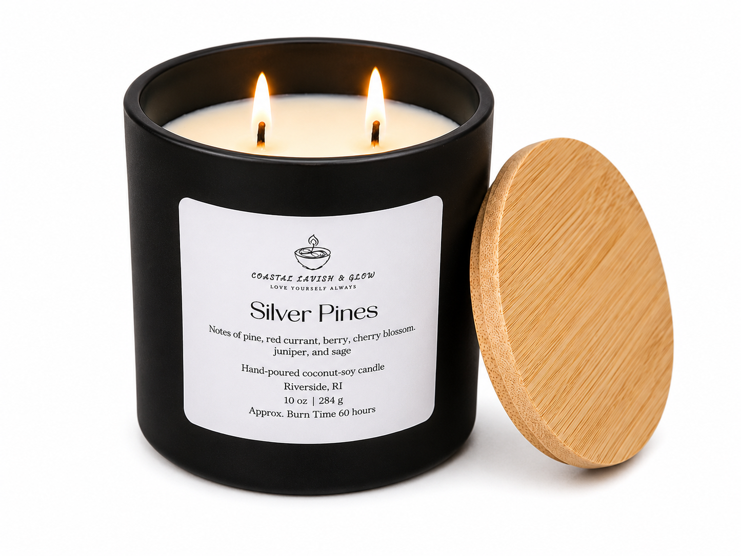 Candle in a black container with a wooden lid, labeled 'Silver Pines', on a white background.