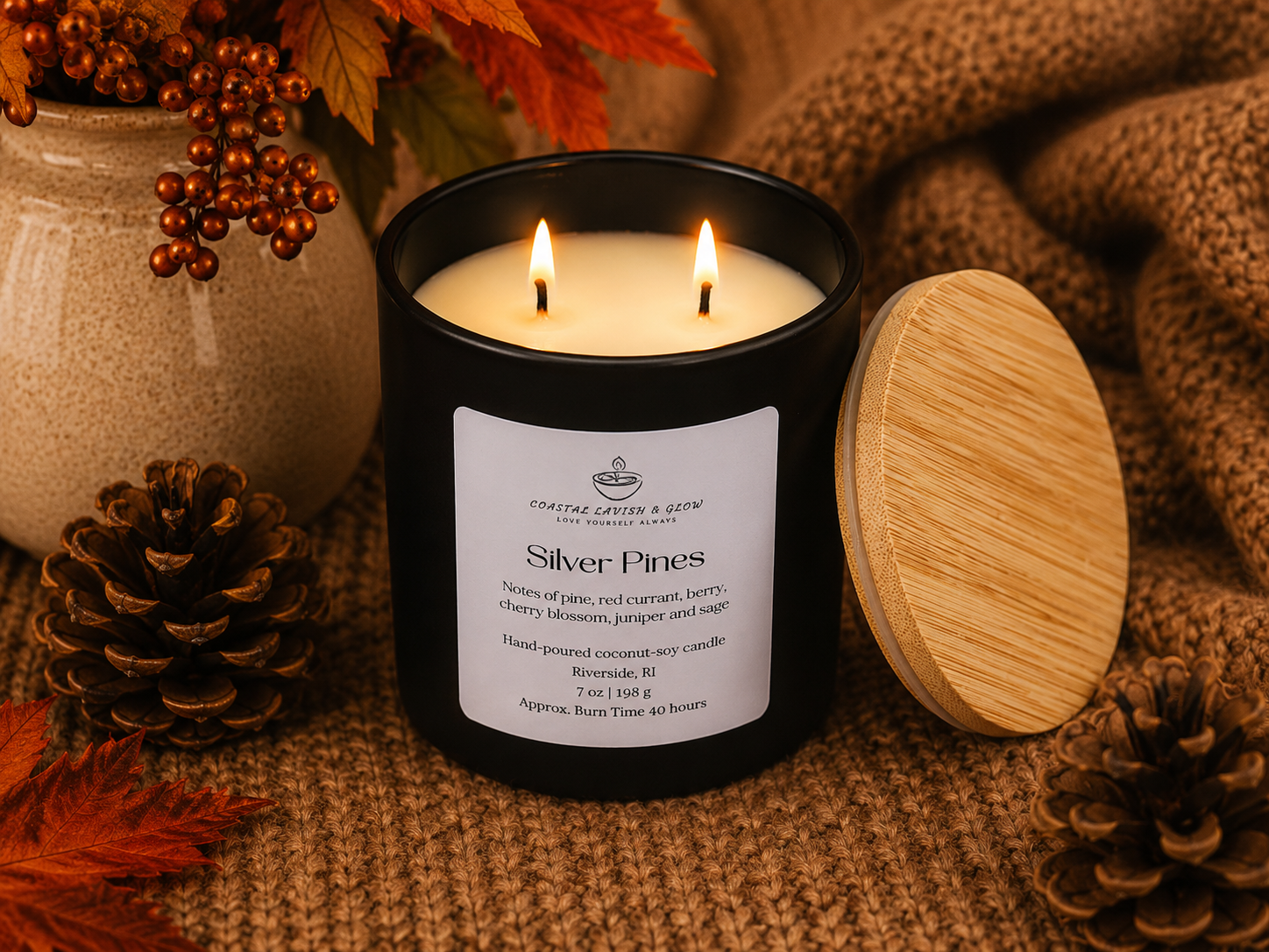 Black candle with wooden lid on a textured surface with autumn decorations
