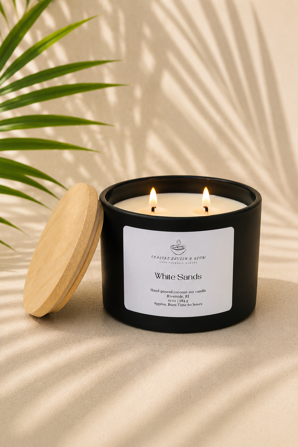 "White Sands" black candle with wooden lid on a beige surface with a plant in the background